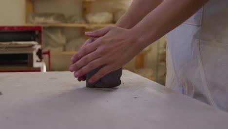 young female potter working in her studio