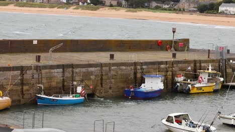 boats docking and people working at pier