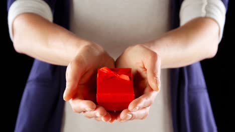 close-up of hand holding small red gift box 4k