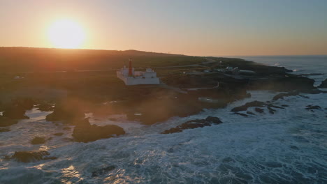 majestic sunrise ocean coast aerial view. lighthouse standing on coastal plain