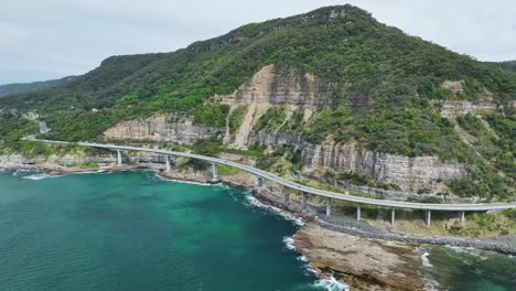 overhead view of sea cliff bridge hugging the cliffs above the pacific ocean in nsw australia