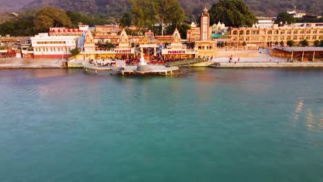 holy ganges riverbank filled with religious temples at evening aerial shot video is taken at parmarth ashram rishikesh uttrakhand india on mar 15 2022