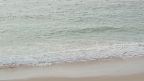 blue ocean where the waves break on the beach