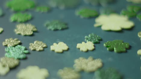 close up studio shot of green shamrock shapes on background to celebrate st patricks day