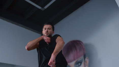 dancer looking at camera while dancing indoors. handsome man rehearsing studio