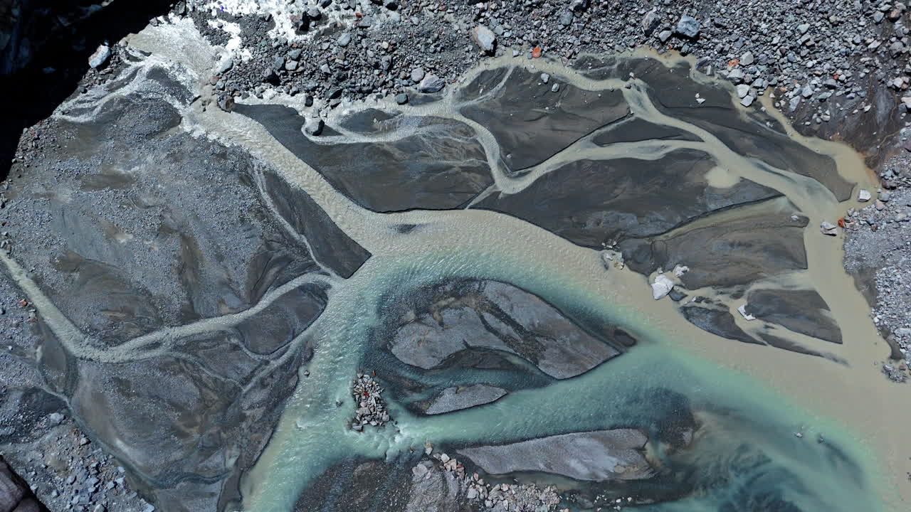 Aerial view of Morteratsch Glacier rivers flowing through rocky landscape