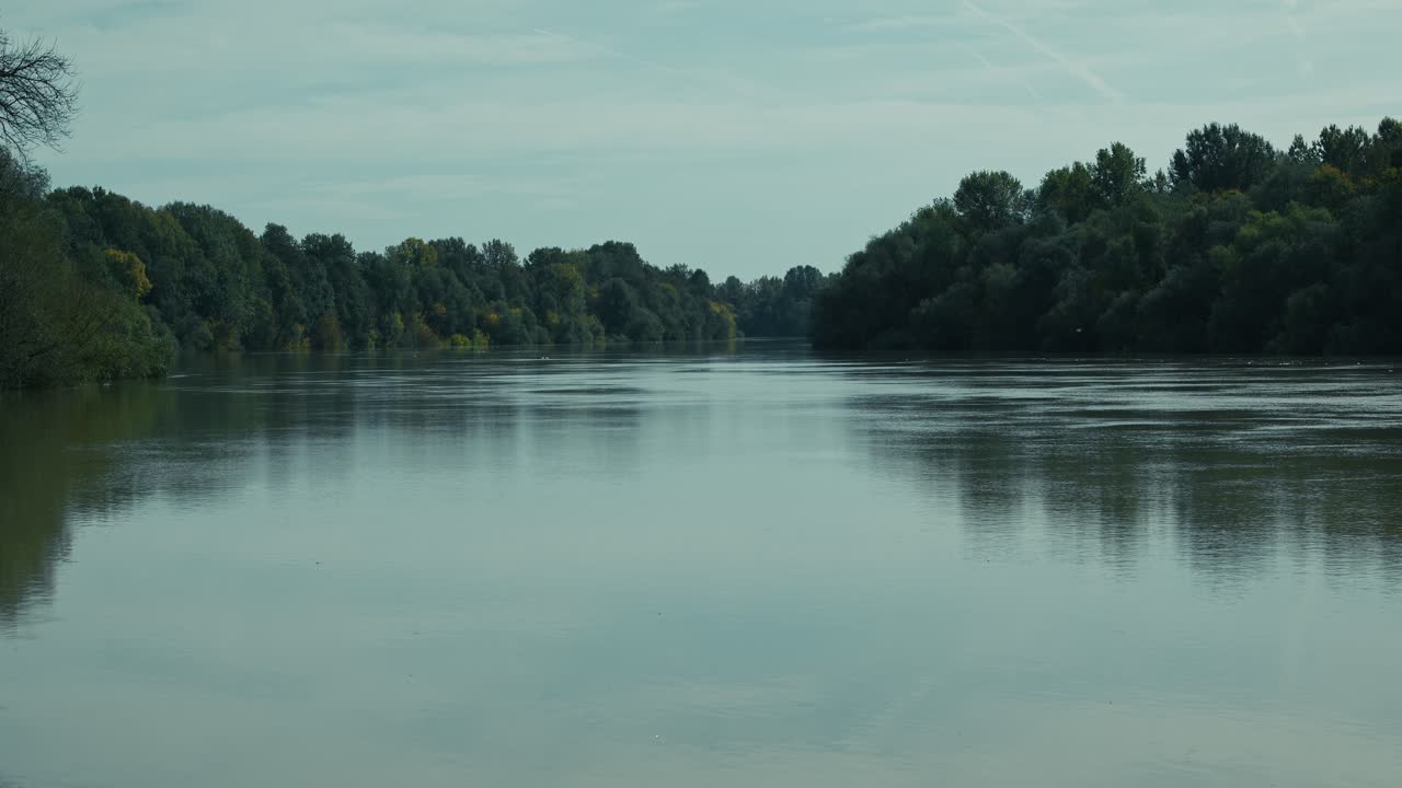 Serene river with lush green trees reflecting on the water in Lonjsko polje Krapje Croatia