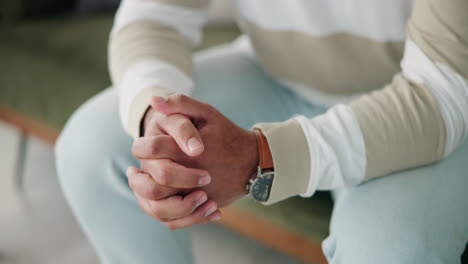 a person with their hands clasped wearing a watch