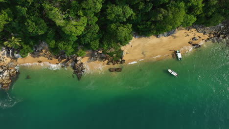 Aerial-view-over-boats-moored-at-a-paradise-beach,-sunny-day-in-Central-America