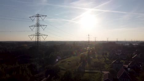 Drone-shot-of-a-sunset-in-a-village-on-the-edge-of-a-forest