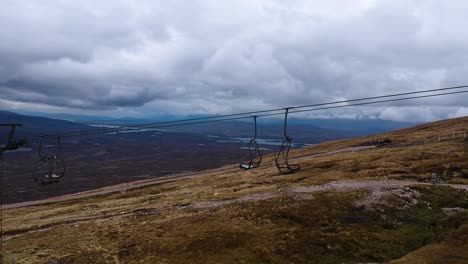 Cinematic-panning-drone-shot-of-mountain-lift-on-top-of-scottish-highland-mountain