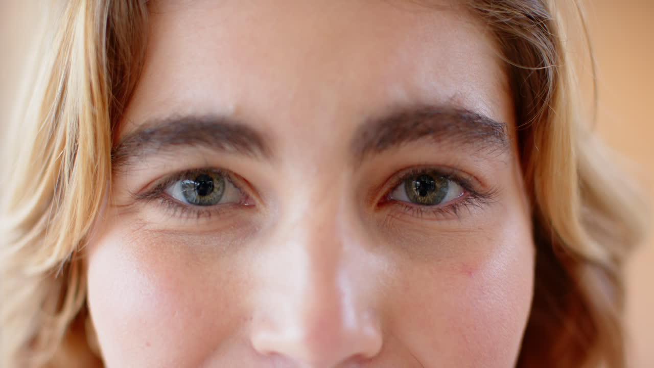 Close-up of woman's eyes, expressing joy and warmth at home during Christmas