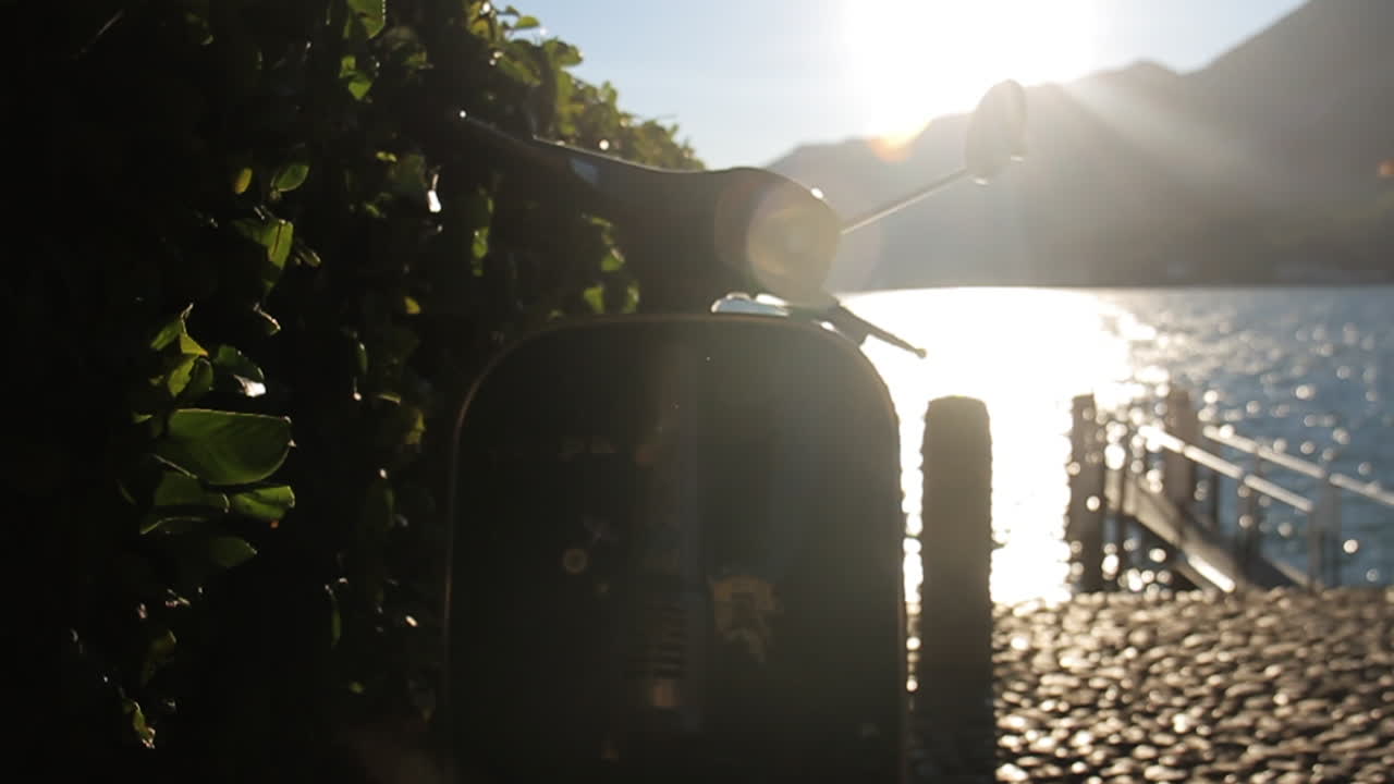 Vespa by the lake at sunset
