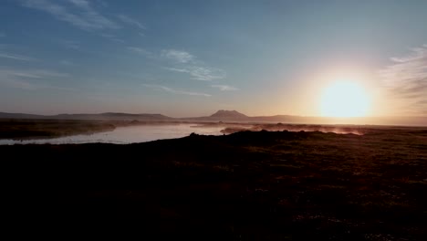 tranquil scenery of morning mist and ponds in south iceland - aerial drone shot