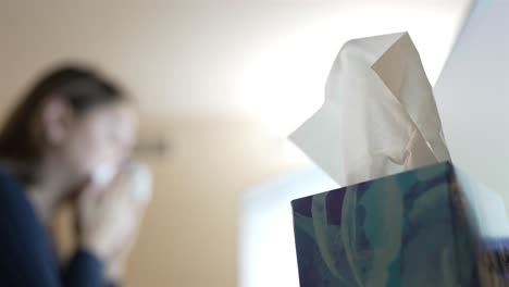 close up hand extracting tissue from the dispenser, office hygiene.