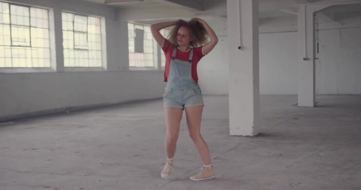 Female dancer shifting and spinning activating social media icons to boost engagement in warehouse