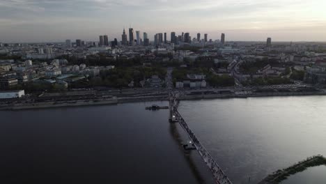 Aerial-View-Of-People-Crossing-The-Agrafka-Bridge-Over-The-Vistula-River-In-Warsaw,-Poland