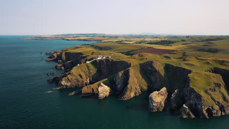 Aerial-Shot-Of-St-Abbs-Head-And-Lighthouse-On-Scottish-Coast-Near-Edinburgh,-Scotland,-United-Kingdom