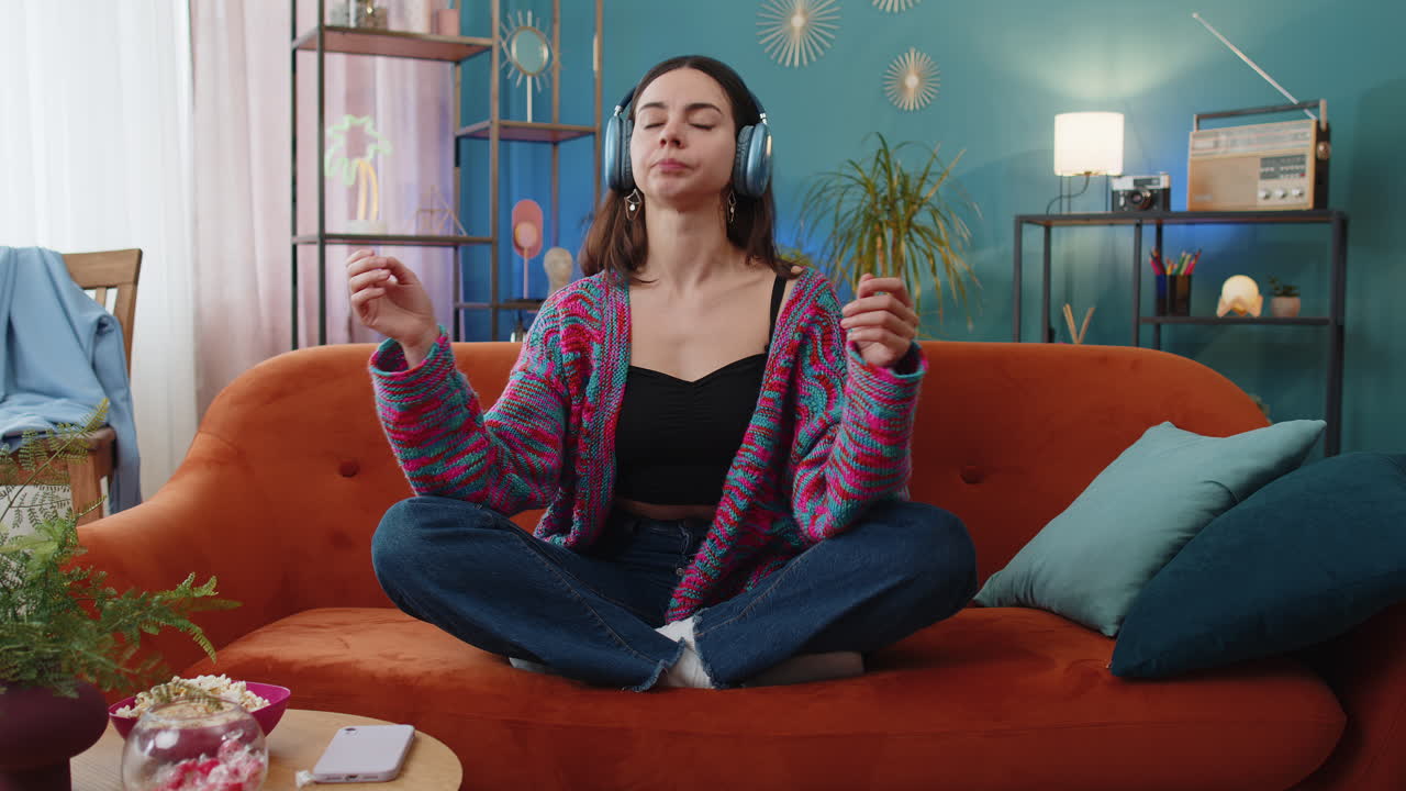 Woman breathes deeply with mudra gesture eyes closed meditating with concentrated thoughts peaceful