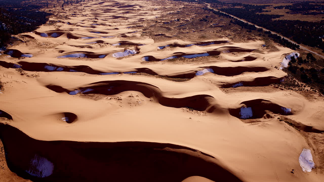 Southern Utah’s pink dunes display an array of vivid hues and textures in this top-down drone shot.