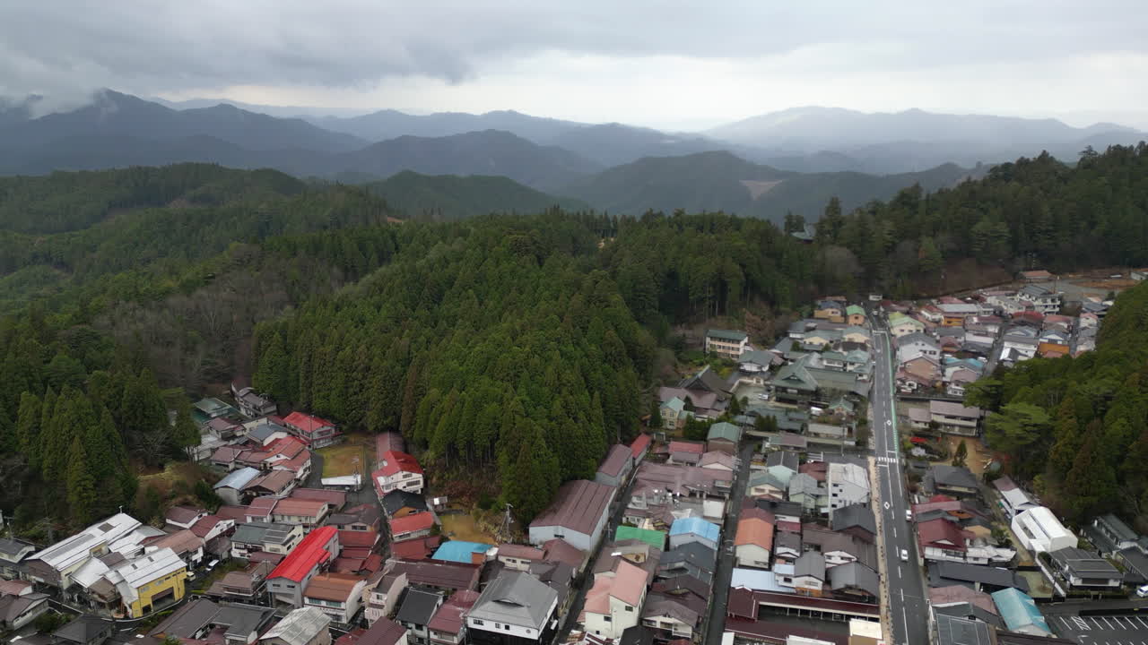 Aerial view flying over the towscape of Mount Koyasan, cloudy fall day in Japan