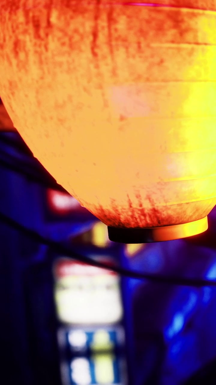 Lantern shines in a busy shop filled with colorful lights and wires