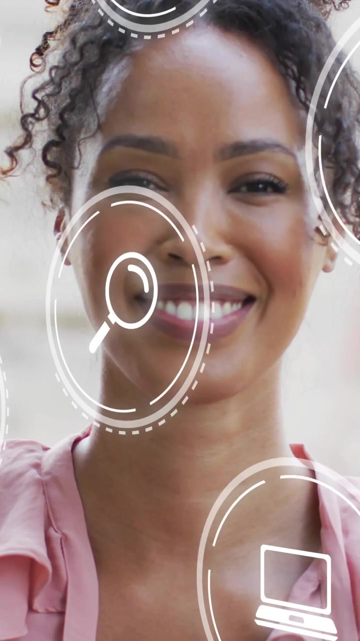 Vertical video: Woman smiling and laughing as education icons appear and orbit, promoting learning