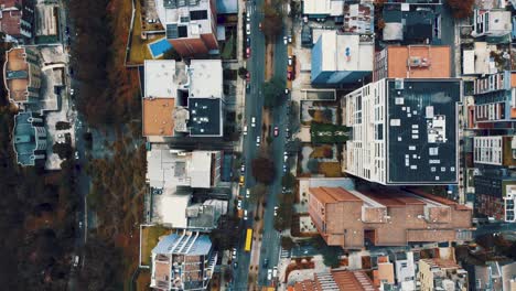 Top-shot-over-the-city-in-Ecuador,-South-America-with-the-traffic-on-the-road