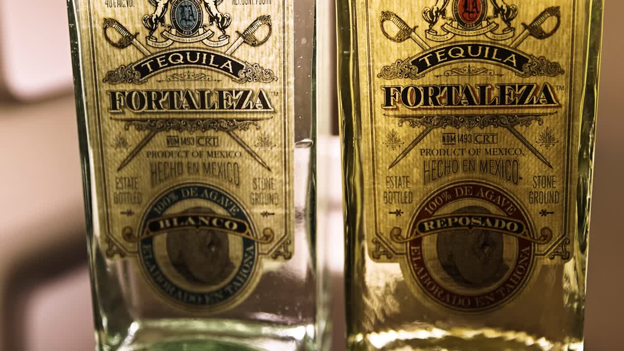 Two bottles of Fortaleza Tequila, including Blanco and Reposado varieties