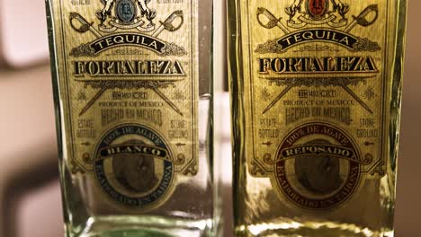two bottles of fortaleza tequila, including blanco and reposado varieties