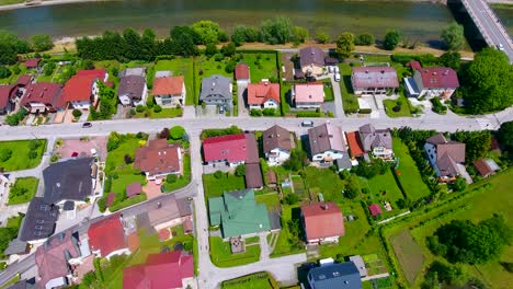 aerial drone fly above celje town slovenia neighborhood houses green gardens and quiet roads with cars passing by in east europe