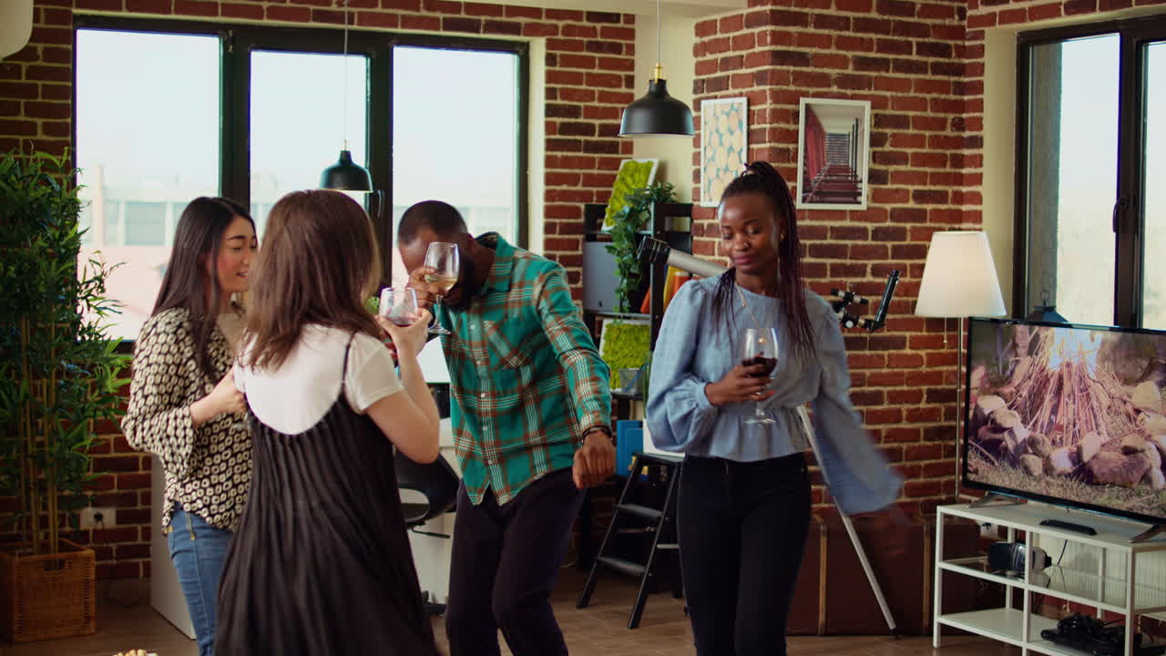 Smiling friends dancing on lively beats during weekend hangout, shaking hips