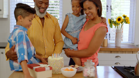 front view of black family celebrating birthday in kitchen of comfortable home 4k