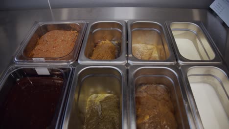 food ingredients inside metal storage tray on restaurant kitchen table