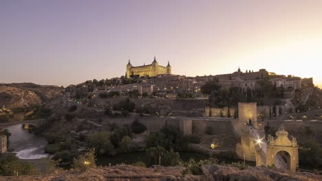 illuminated historic city on hill in evening