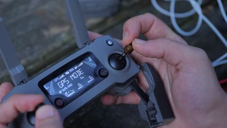 hand using drone controller with sign showing ready to go, gps mode, closeup