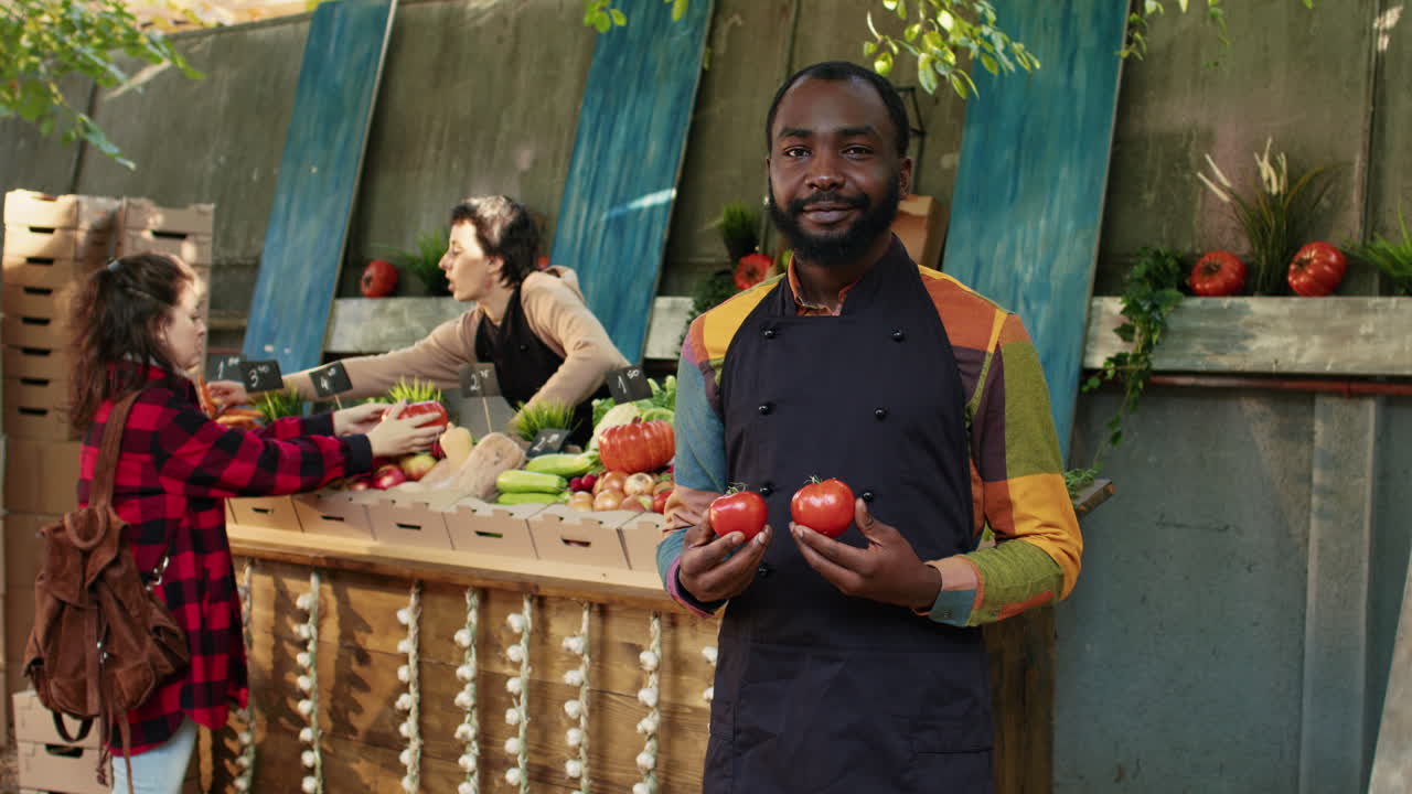 Farmers market with customers buying tomatoes and vegetables