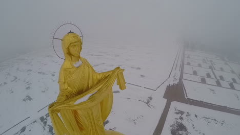 flying over the golden saint on belfry top