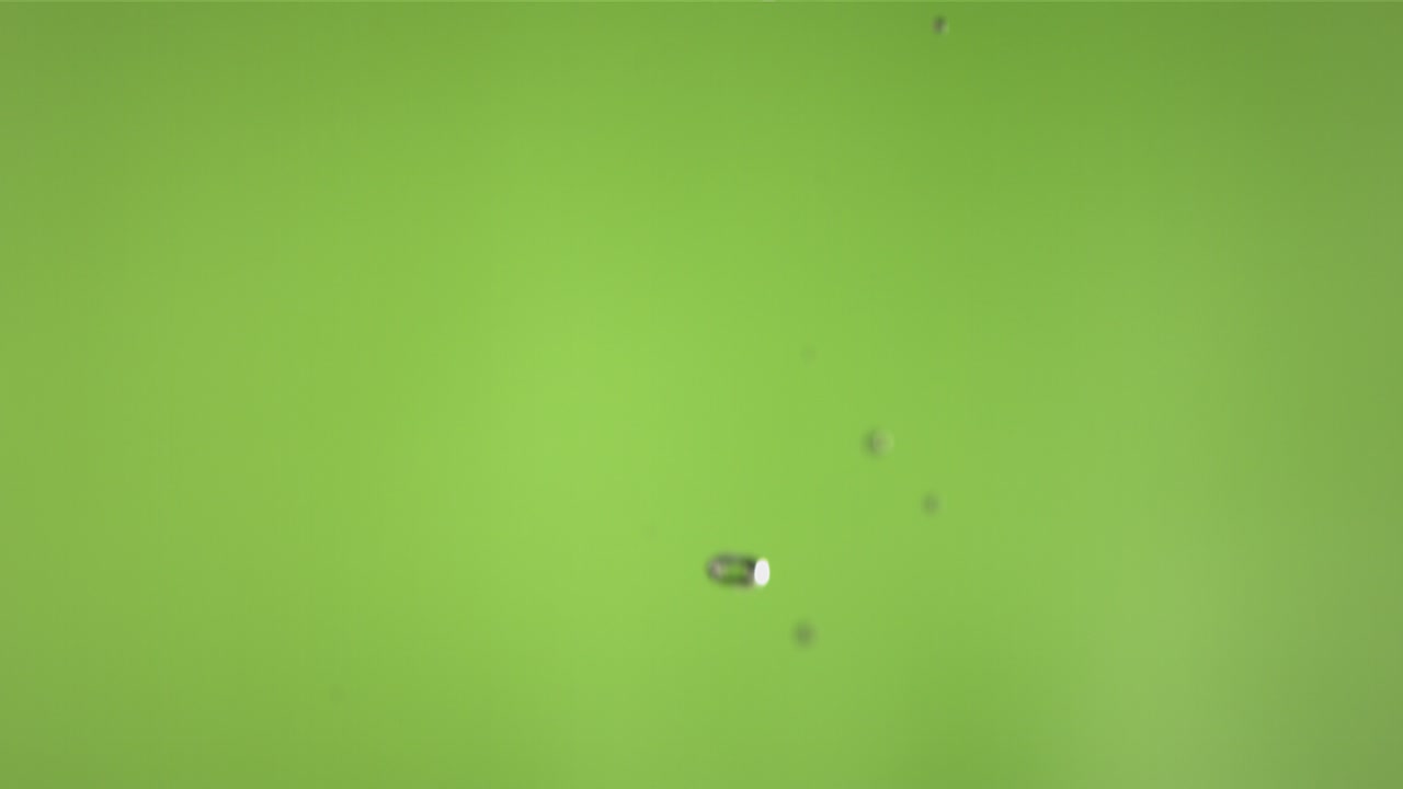 Flying of Green Apple in Green Background in Slow Motion