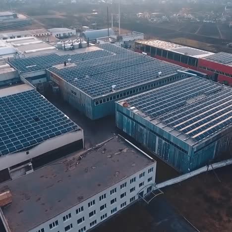 top view of solar farm on the industrial buildings. photovoltaic solar panels on roofs at sunset. new source of ecological energy. aerial view.
