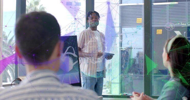 Project lead tapping tablet activating node graphics on glass presenting VR headset for tech pitch