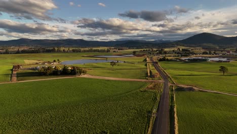 4k60 amazing landscape green fields with road and mountains, tasmania australia