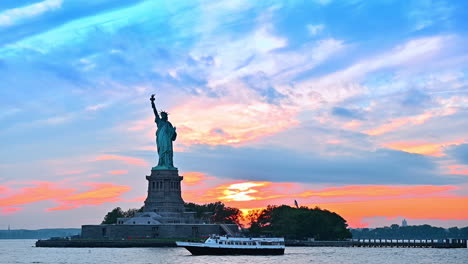 statue of liberty at sunset with a boat