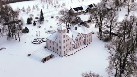 a snow covered house with a white roof and a white trim