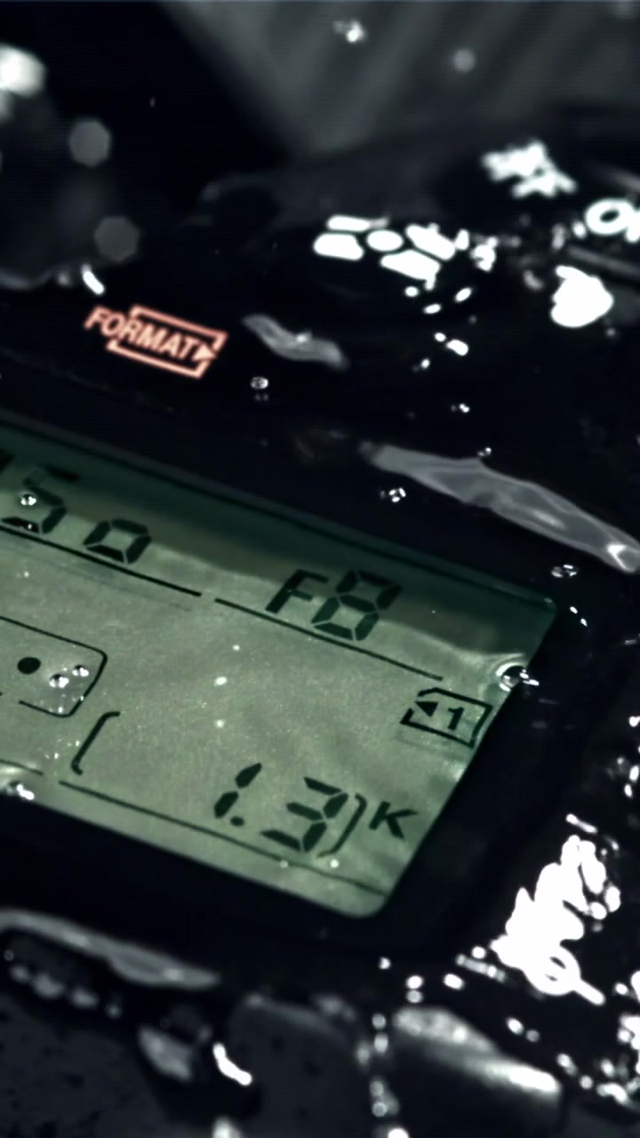 Close-Up of Water Drops Falling on a DSLR Camera Display
