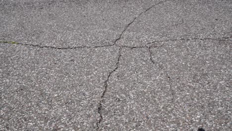 Pan-of-Cracking-Pavement-During-Day