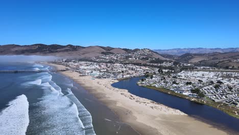 soar above pismo beach, capturing the stunning ocean views and majestic mountains in the background with this breathtaking aerial drone footage