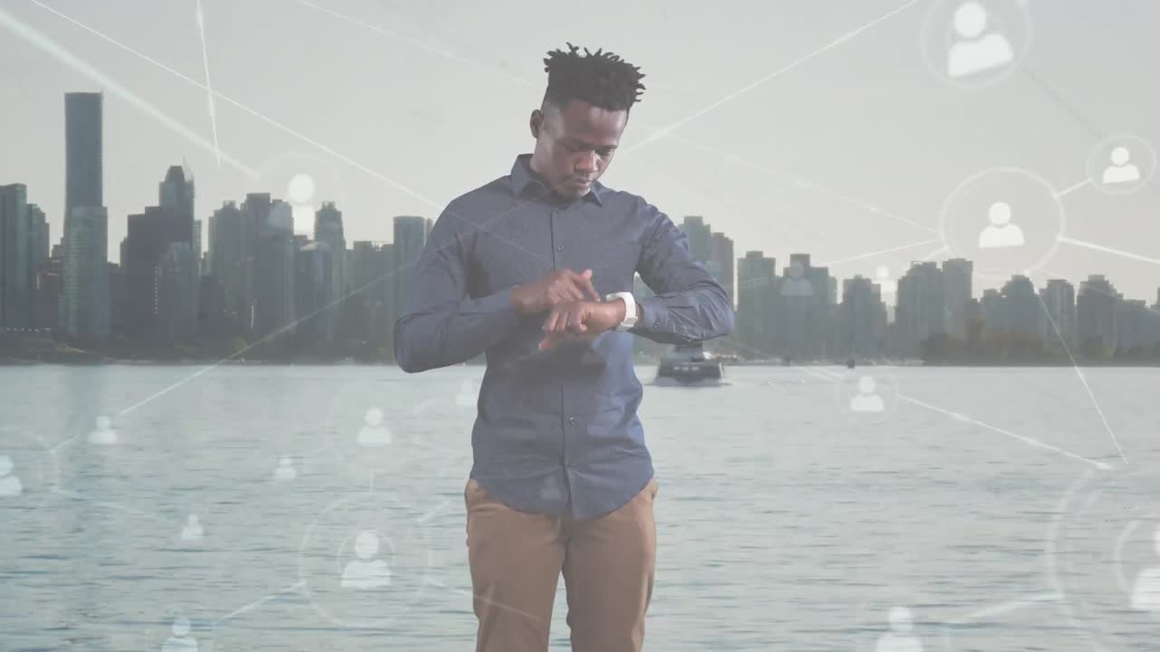 Animation of african american businessman using smartwatch over cityscape