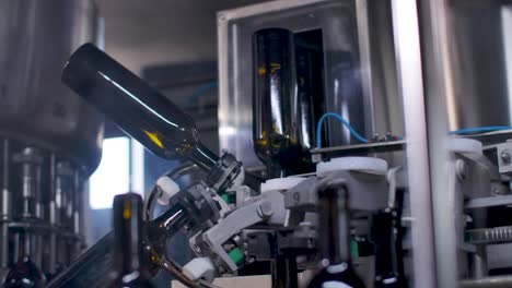 empty bottles intended to be filled with wine, handled by a conveyor machine at a winery