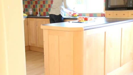 Brunette-woman-rinsing-vegetables